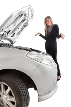 Woman having car trouble with an opened hood - isolated over a white